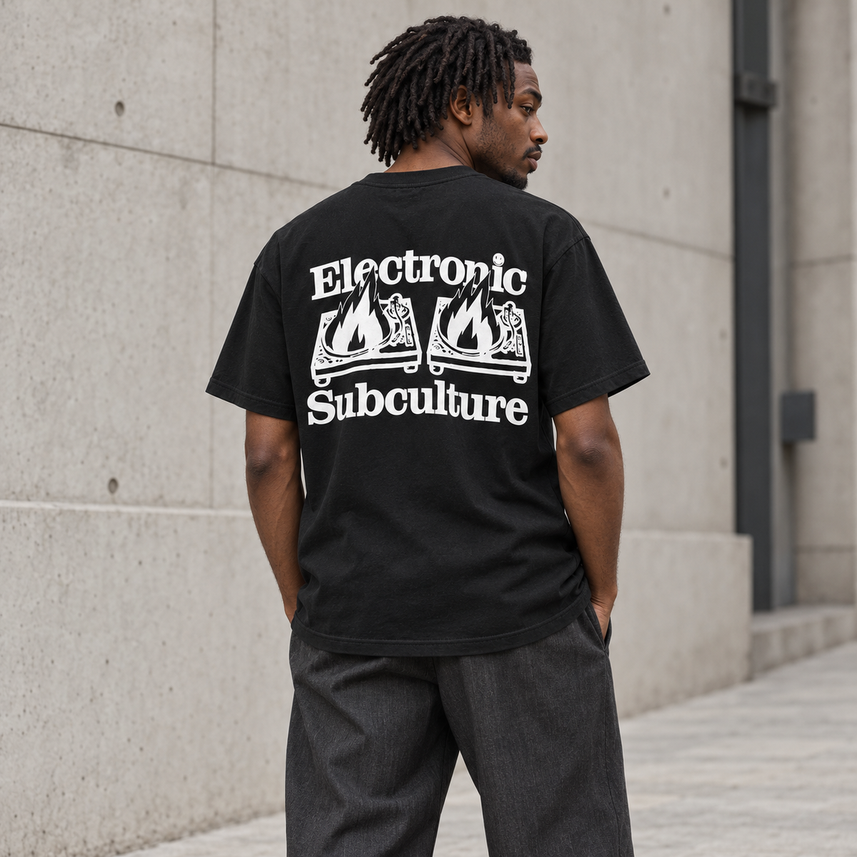 Model wearing the black Electronic Subculture Decks on Fire T-shirt, showing the white back print