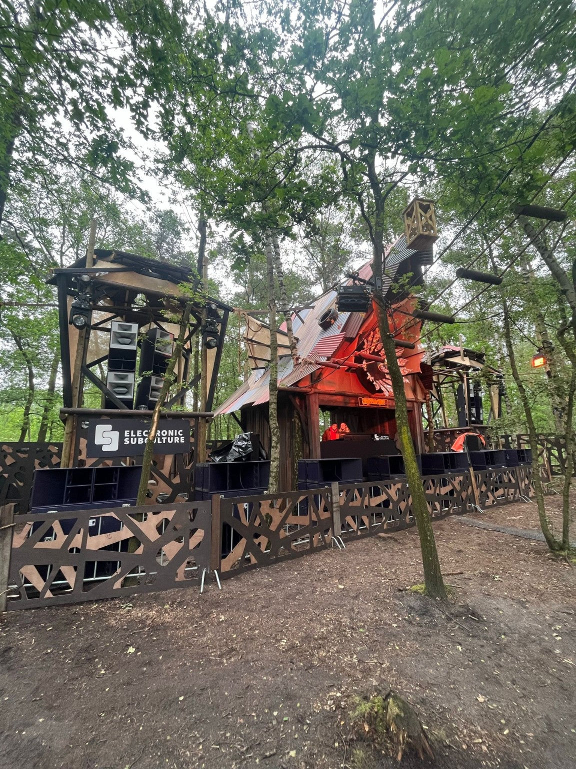 Electronic Subculture forest stage with branded booth
